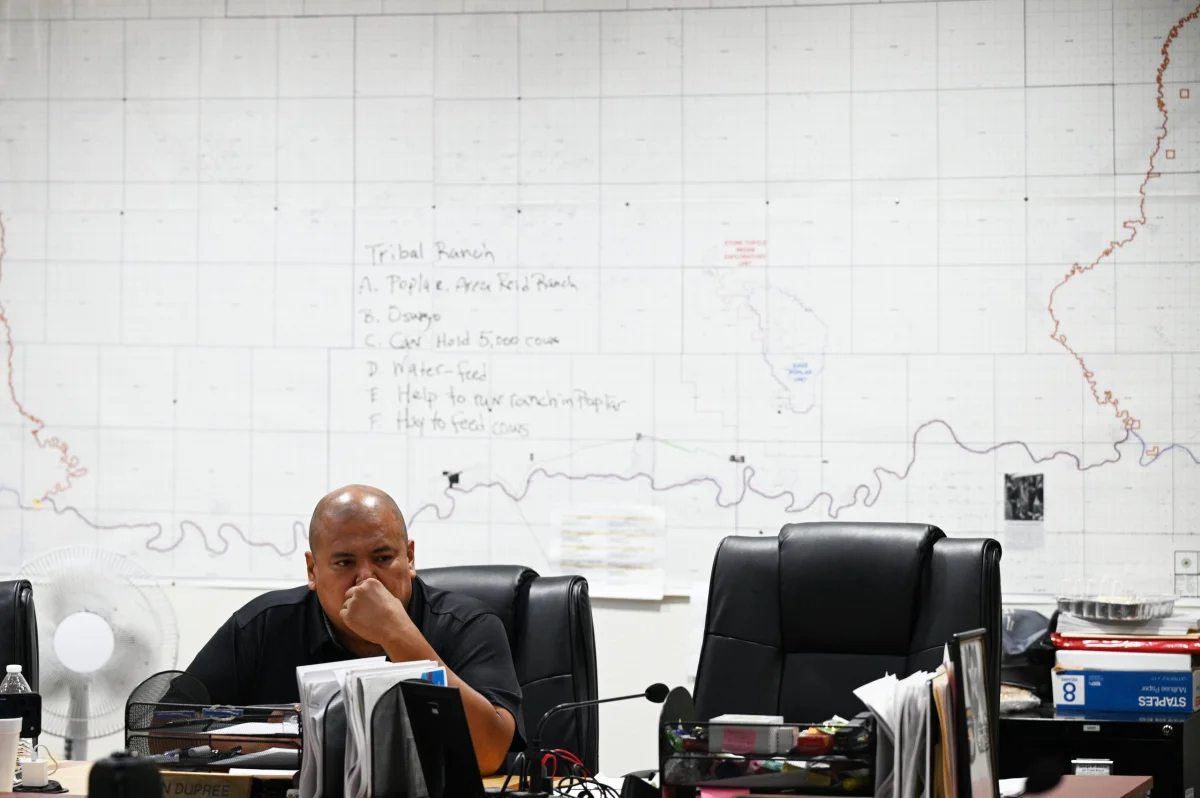 Jestin Dupree sitting at a desk with a map on the wall behind him